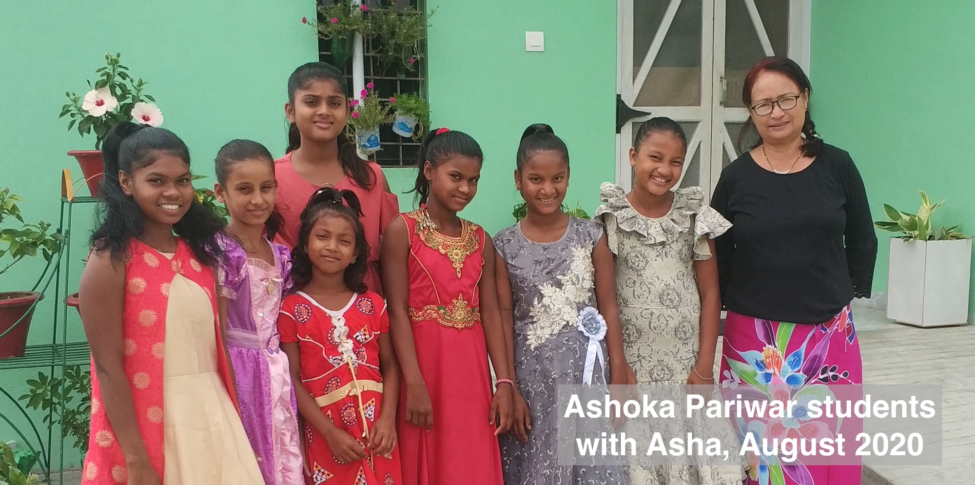 7 girls and Manager Asha Pradhan outside Ashoka Pariwar hostel, Lalgadh