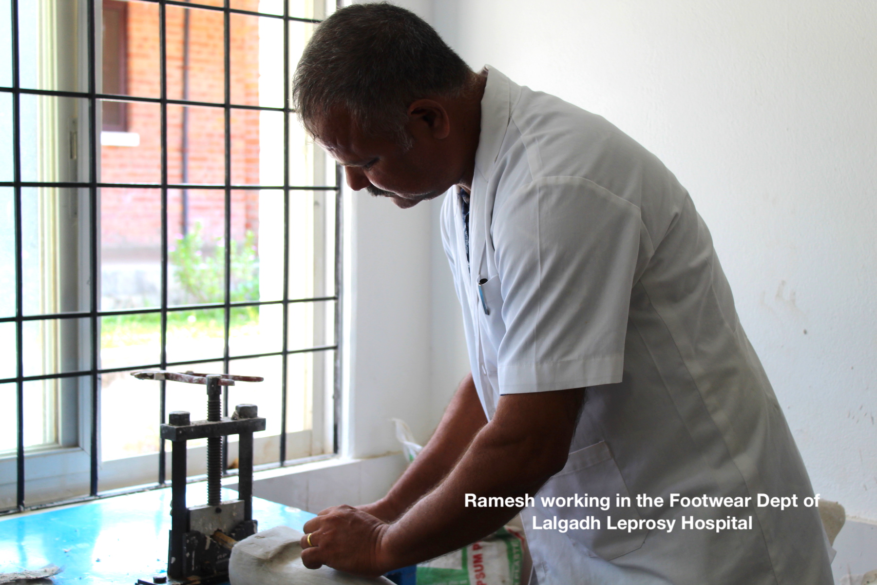 Man Ramesh working on machine in the footwear department at Lalgadh Leprosy Hospital and Services Centre