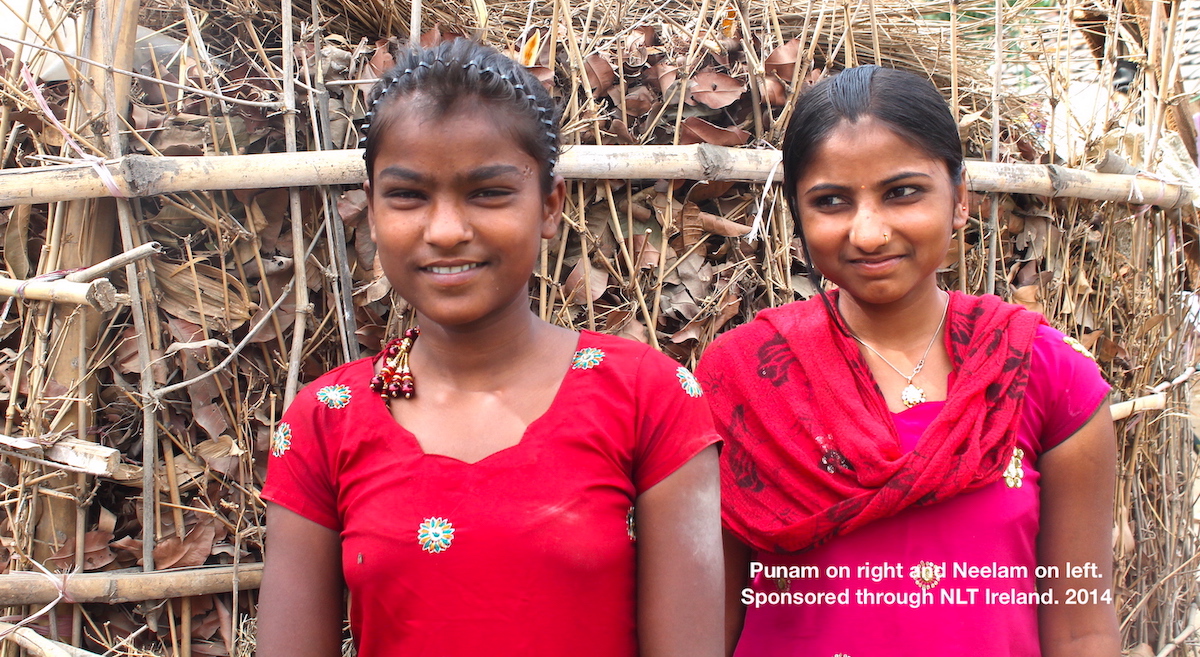 2 girls in red saris Neelam (L) and Punam (R)